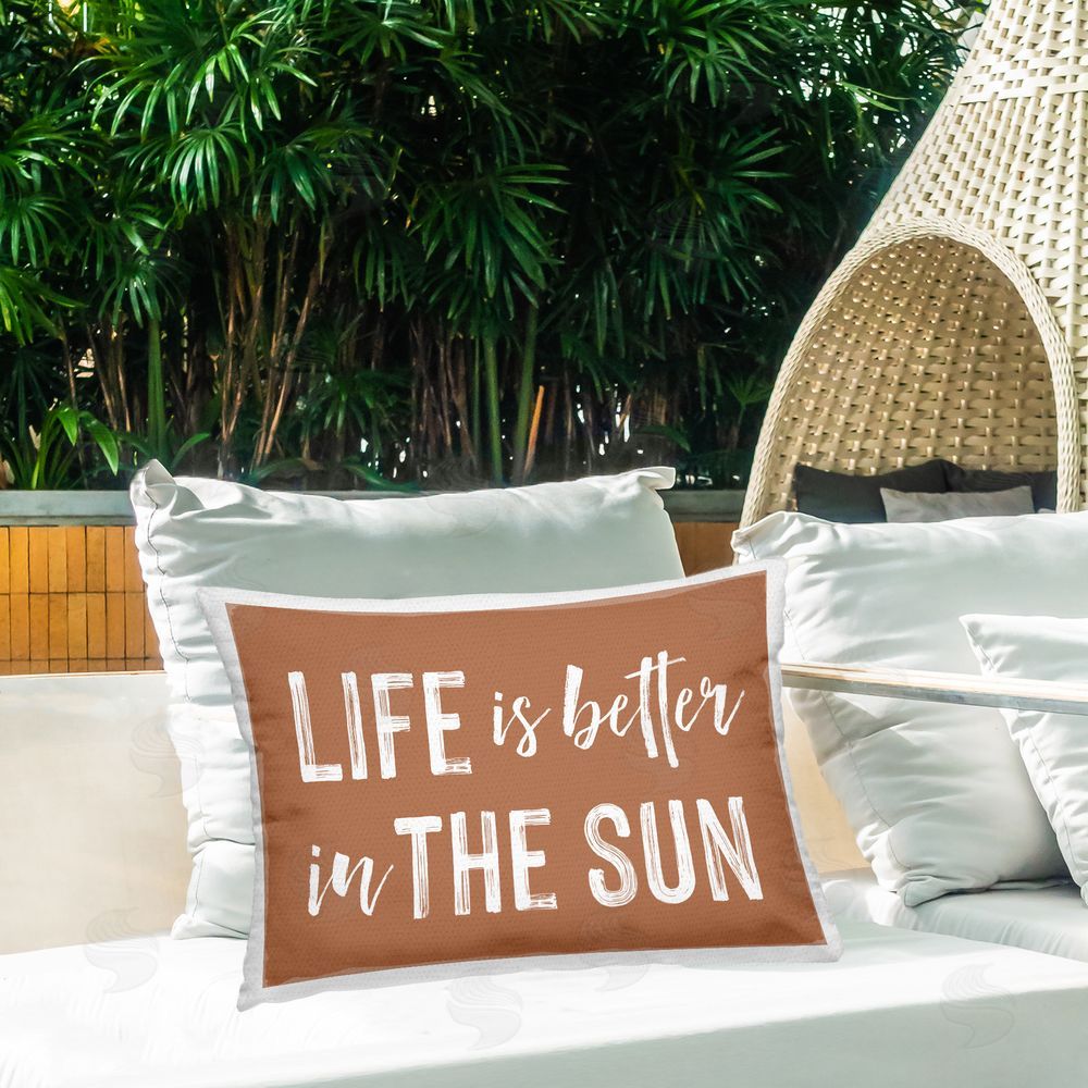 Lettered and Lined Life Better In Sun Brown Outdoor Rectugular Printed Throw Pillow on Patio