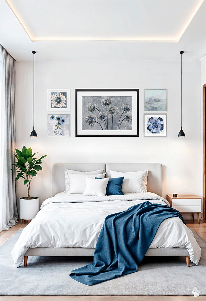 Modern bedroom with 5-piece framed print-under-glass wall art in blue and gray tones arranged above bed with blue accent blanket.