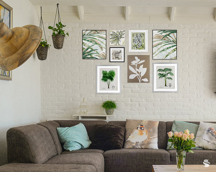 Botanical boho living room with brown sectional sofa, bird-themed pillows, gallery wall of botanical prints, and hanging plants.