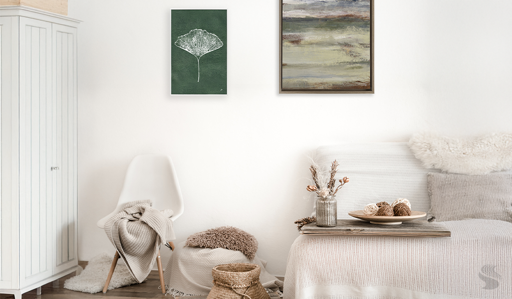 Gallery wall with soft landscapes, botanical art, and earthy abstracts in a light, cozy neutral space.