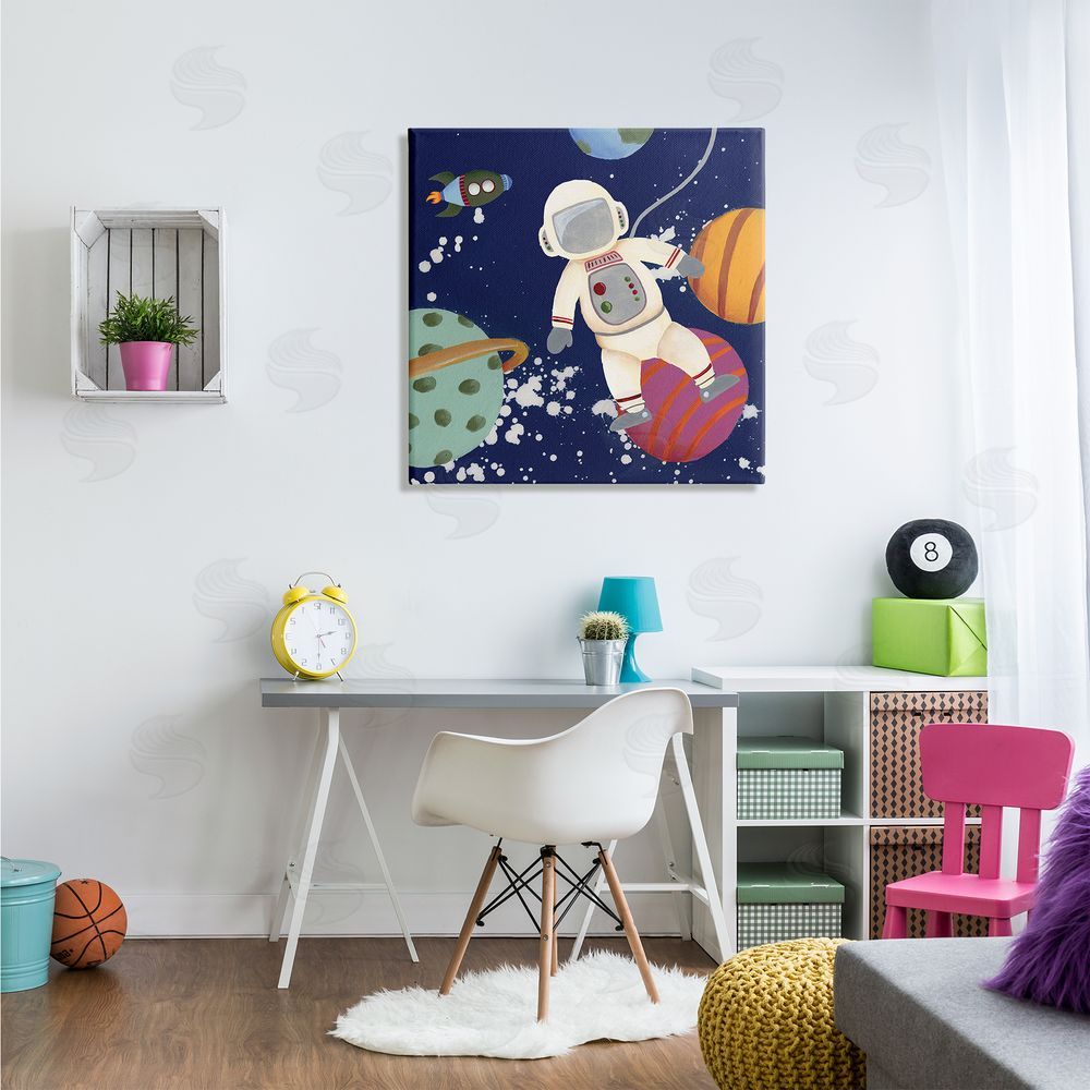Regina Moore Playful Astronaut Floating In Space Planets Rocketship Canvas Wall Art in Room