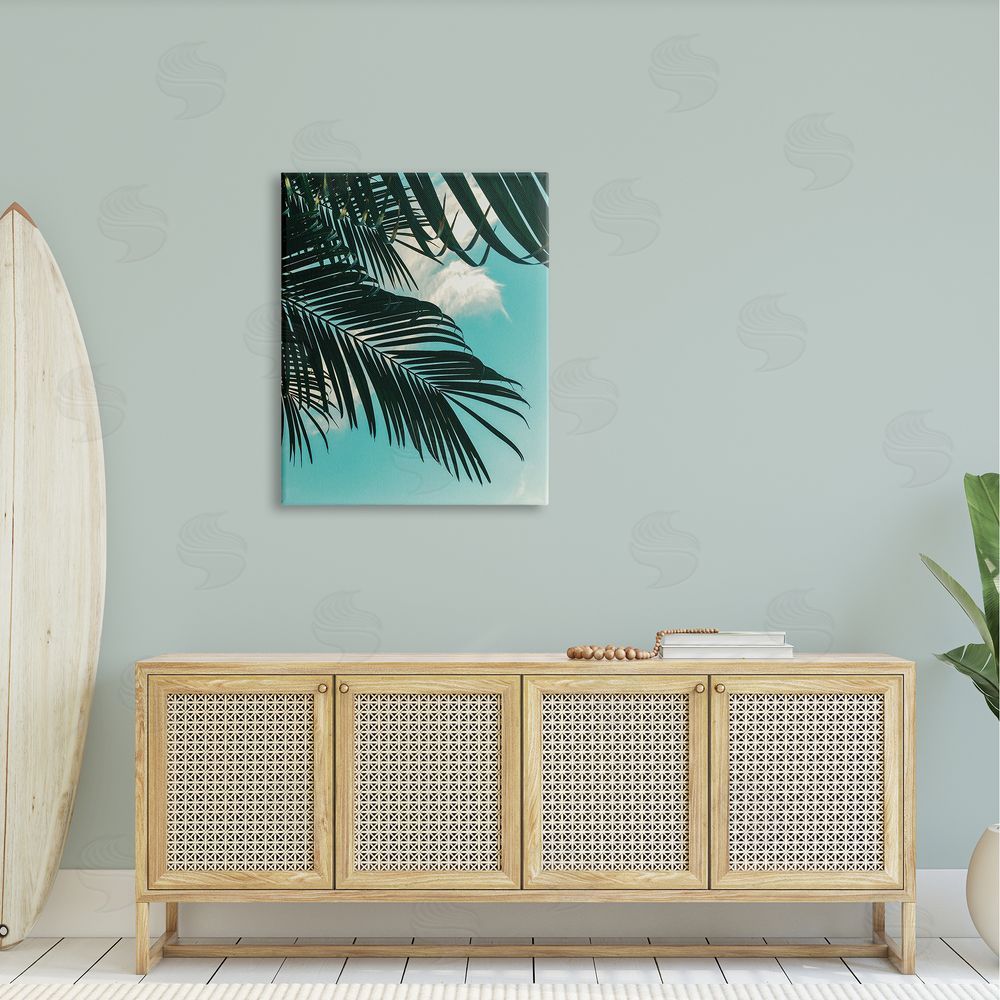 Amy Brinkman Bright Tropical Palm Tree Leaves Against Blue Sky Canvas Wall Art Print in Room