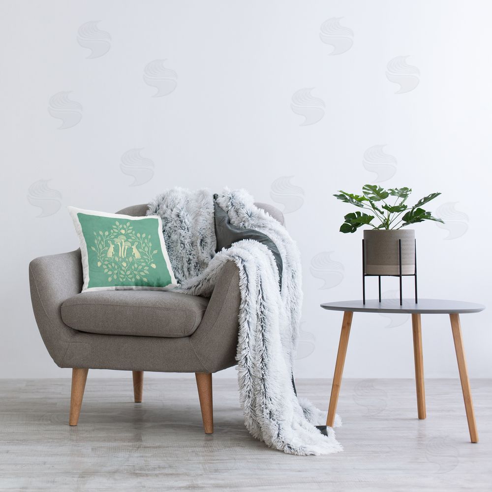 Katie O'Shea Turquoise Botanical Rabbits Printed Plush Polyester Throw Pillow On Chair