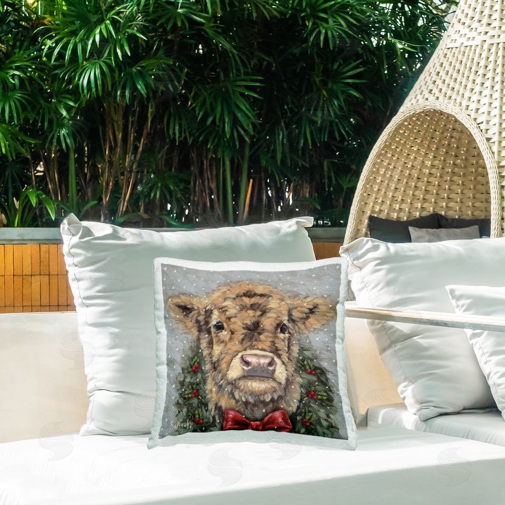 Sara G. Designs Snowy Day Christmas Cow Outdoor Printed Throw Pillow on Patio
